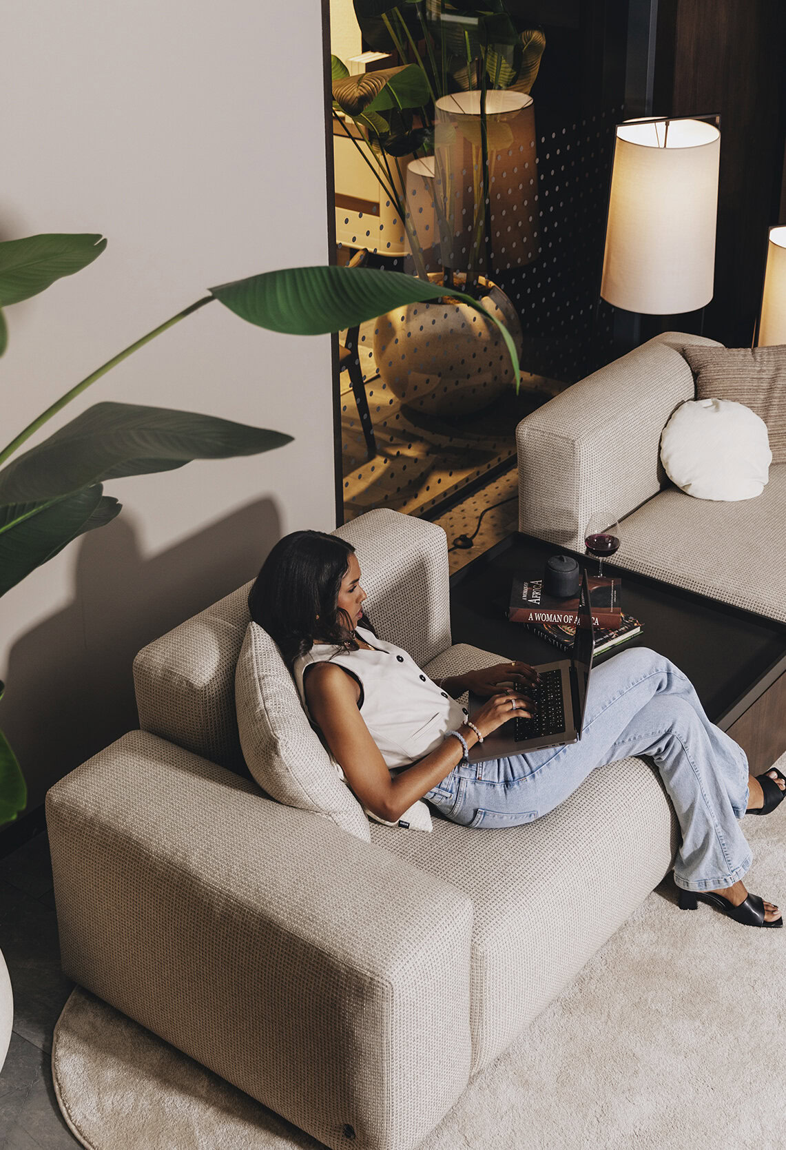 Modern beige fabric sofa with plush cushions in a stylish living room setting, perfect for relaxing or working from home.