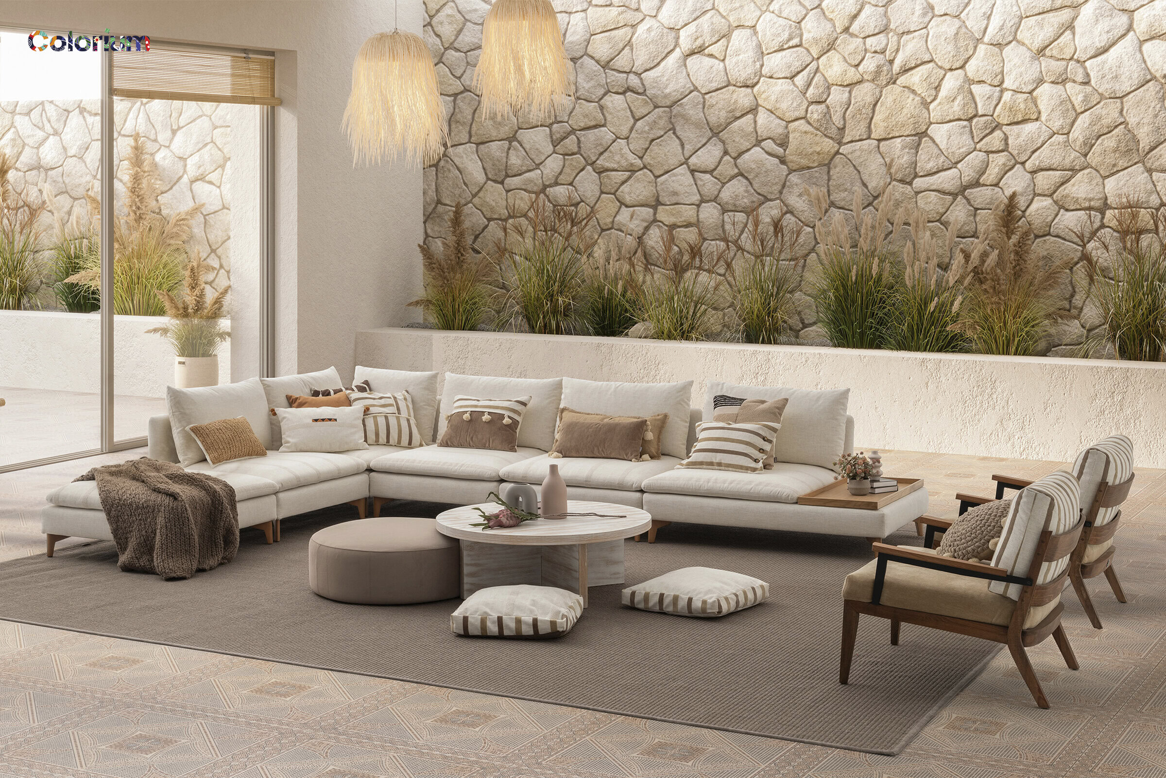 Stylish living room featuring a large white sectional sofa, cozy armchairs, and decorative cushions, complemented by natural stone wall accents and lush indoor plants for a warm, inviting atmosphere.