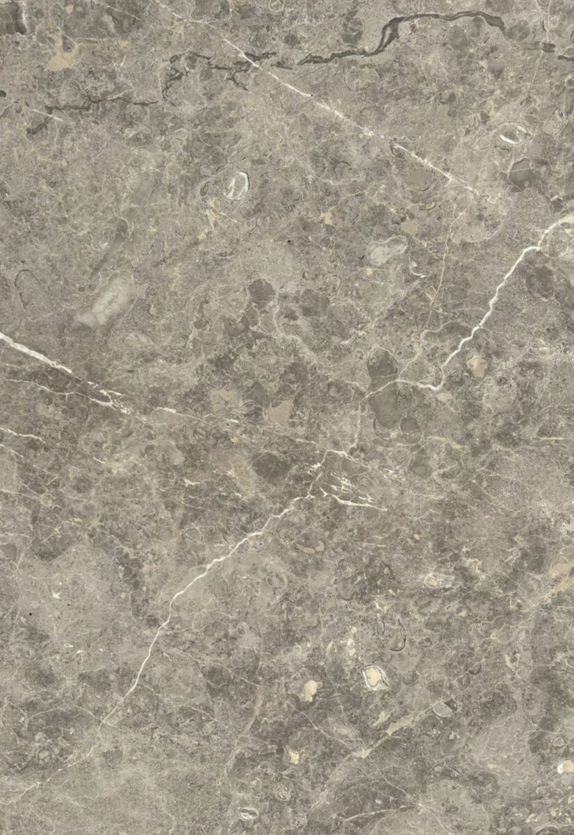 A close-up view of a polished gray marble surface with natural veining and subtle color variations, ideal for furniture, countertops, and interior design accents.