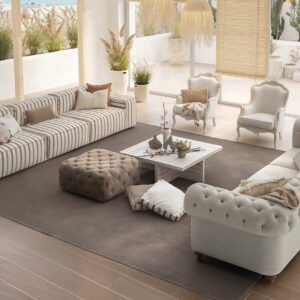 Elegant beige and striped fabric sofas in a bright, airy living room with natural light and stylish decor. Perfect for contemporary home interiors.